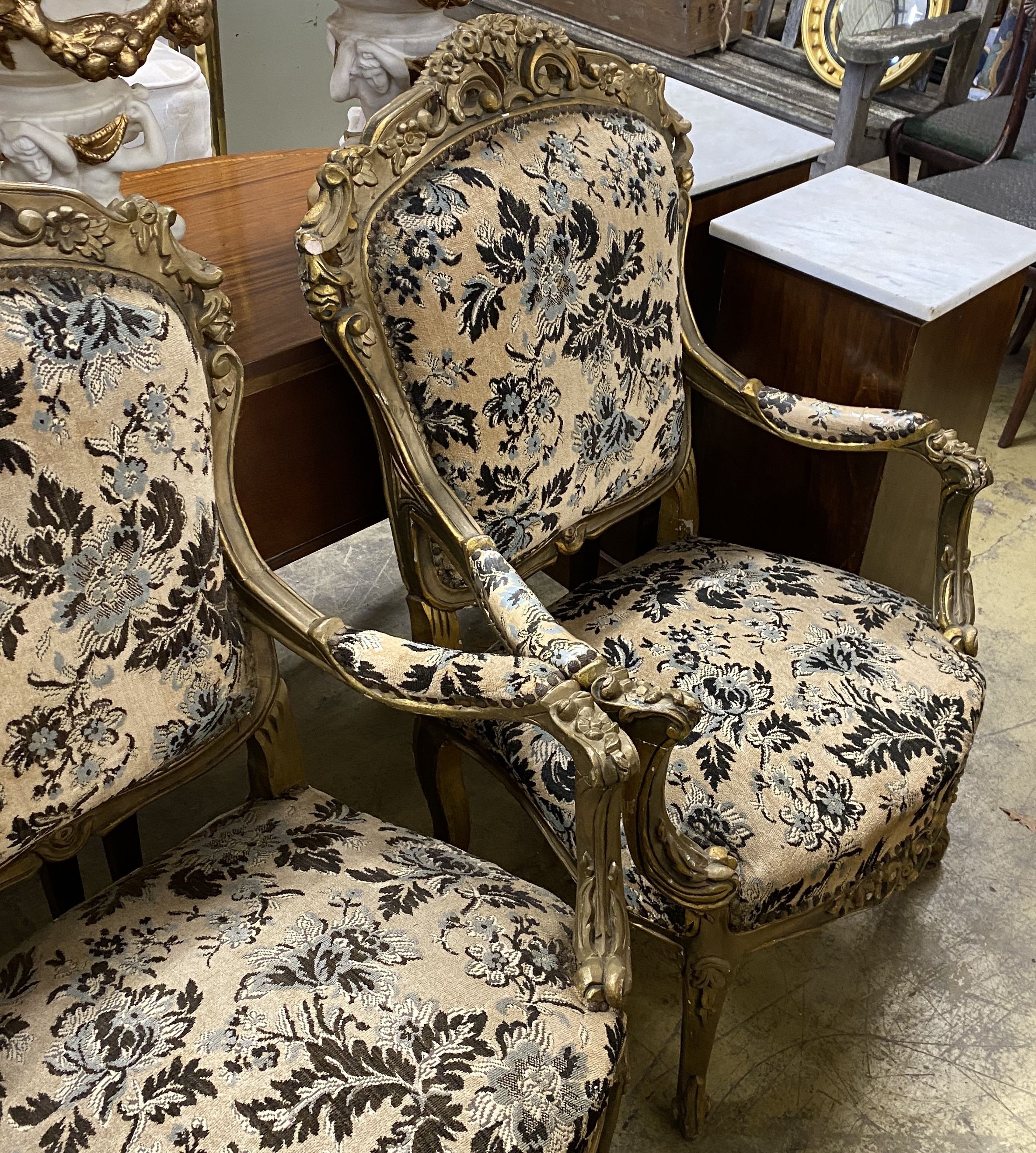 A pair of Louis XVI style carved giltwood upholstered open armchairs, width 72cm, depth 54cm, height 110cm